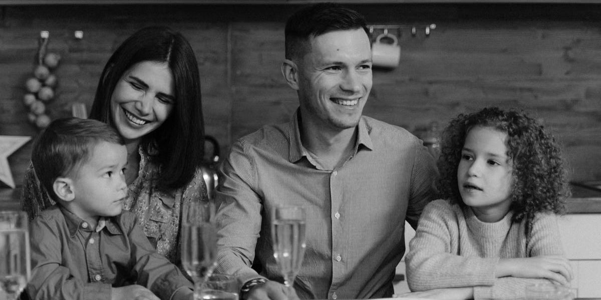 Smiling family enjoying quality time together at dining table in cozy kitchen.