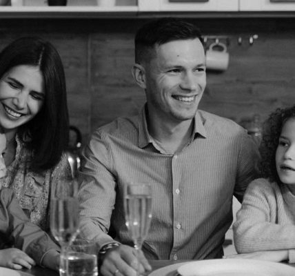 Smiling family enjoying quality time together at dining table in cozy kitchen.